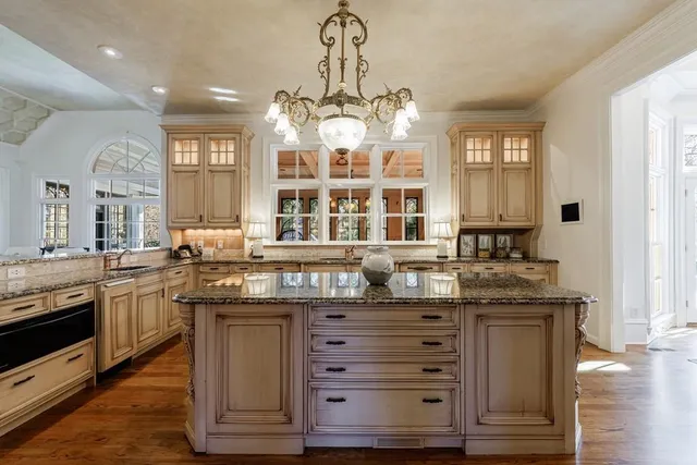 a room with furniture a chandelier and a large window