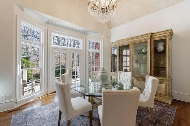 a view of a patio with table and chairs with wooden floor and fence