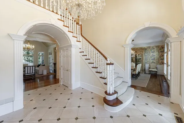 a view of a dining room with furniture and a chandelier