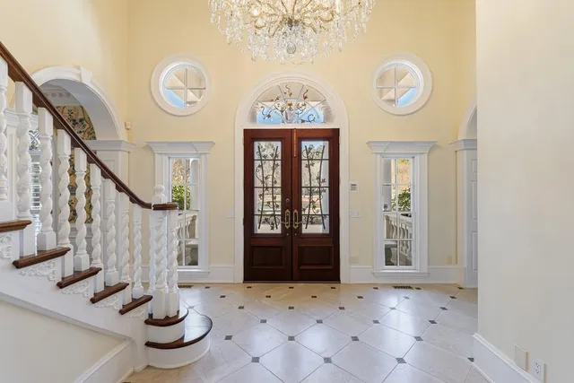 a view of a dining room with furniture a chandelier and wooden floor