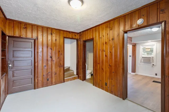 a view of a room with a wooden door