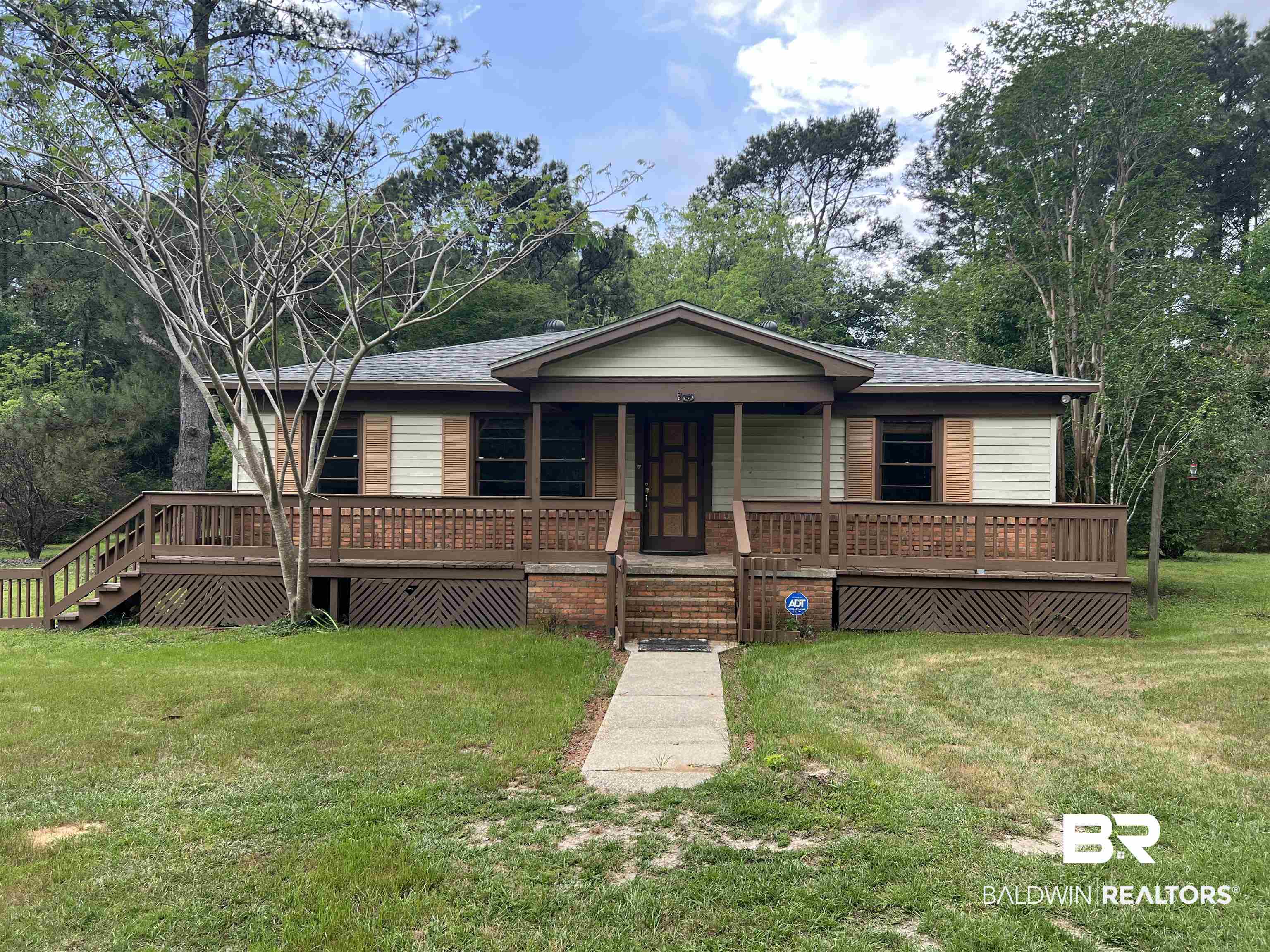 13301 A Hugh Fort Road Grand Bay, AL 36541 - Photo 2 of 34 View of front of house featuring a front lawn, a porch, a shingled roof, and stairway