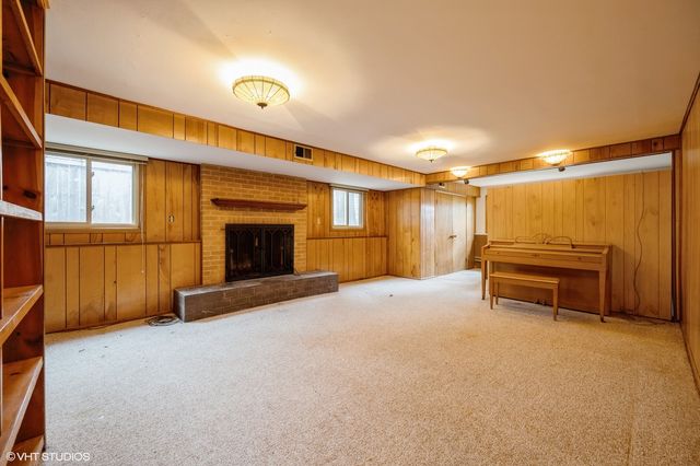 a view of a livingroom with furniture and a fireplace