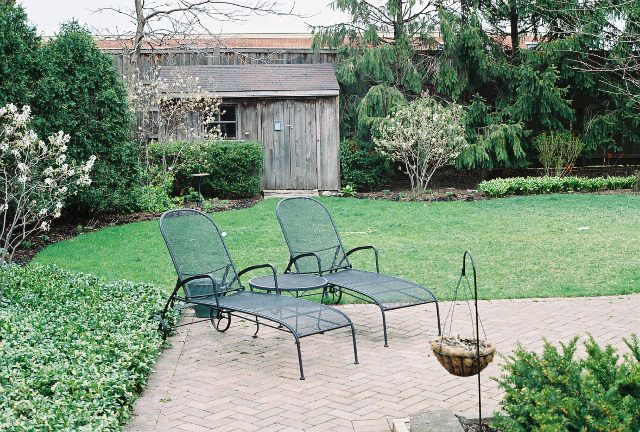 a view of a chairs and table in the garden