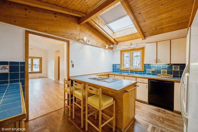 a kitchen with stainless steel appliances granite countertop a stove and a refrigerator