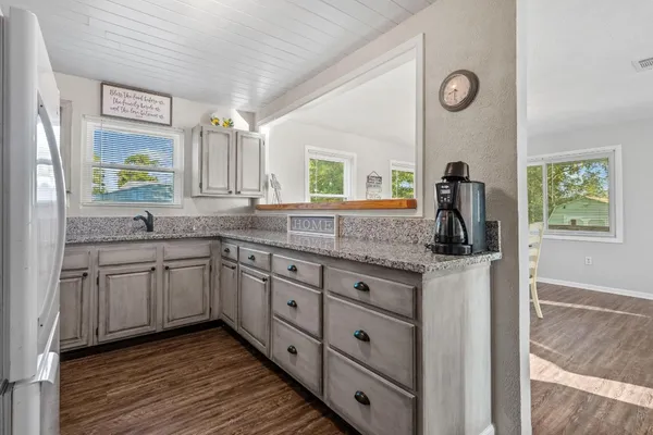 a spacious bathroom with a granite countertop sink and a mirror