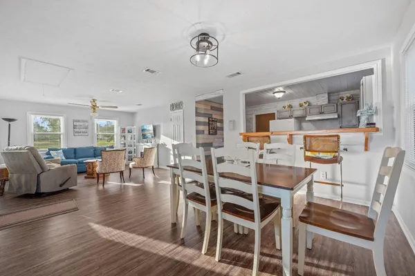 a dining room with furniture a rug and wooden floor