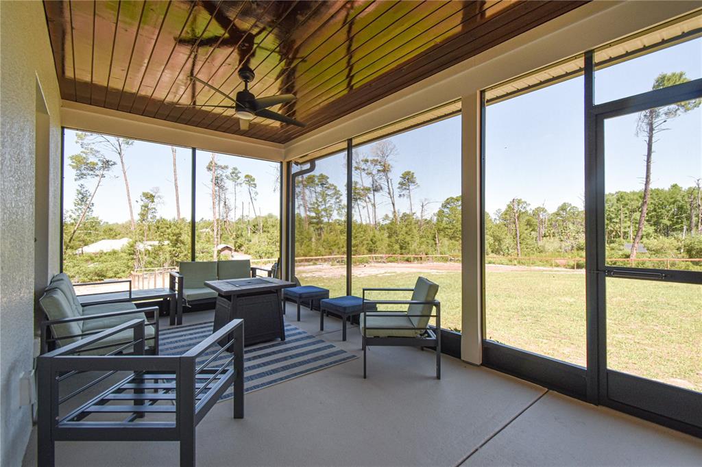 7890 Southwest 129th Avenue Cedar Key, FL 32625 - Photo 32 of 45 a living room with furniture and a floor to ceiling window