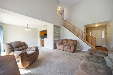 a living room with furniture and a ceiling fan