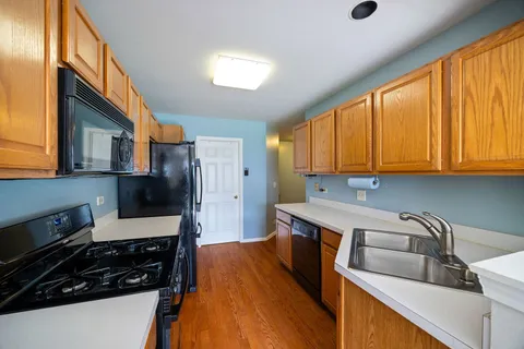 a kitchen that has a sink and a stove