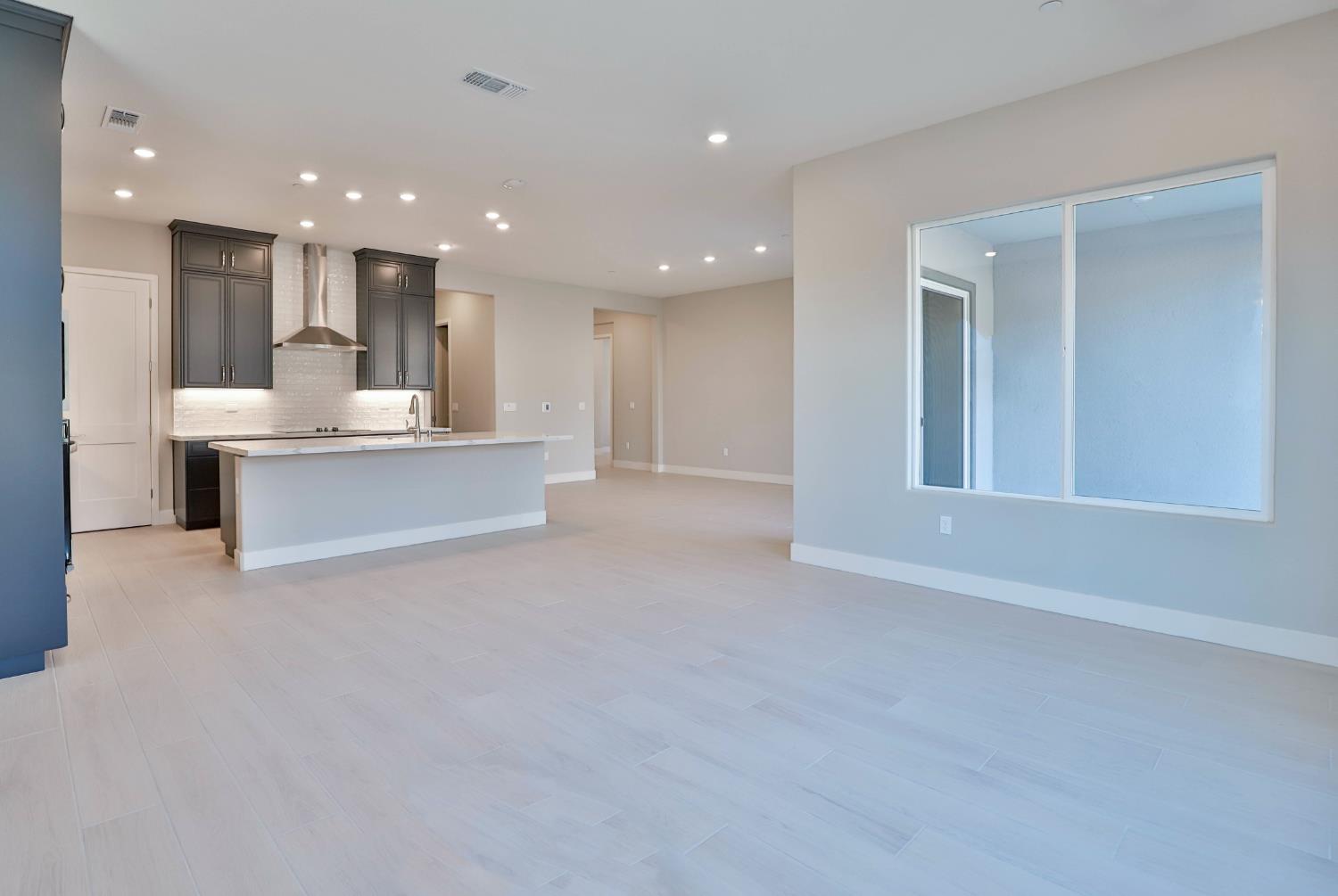 4649 Starglow Drive Penryn, CA 95663 - Photo 11 of 25 a view of kitchen with kitchen island a sink wooden floor and a refrigerator