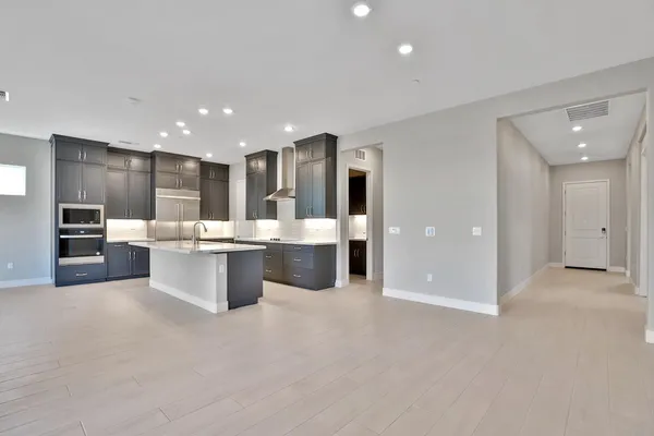 a large white kitchen with a large window