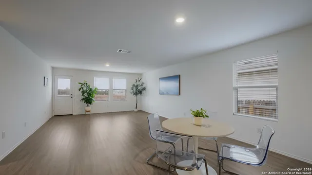 a view of a work space with furniture and wooden floor