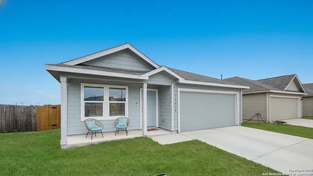 a front view of a house with a yard and outdoor seating