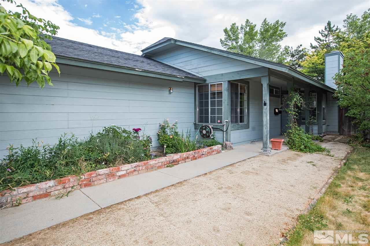 1262 Blue Lakes Road Reno, NV 89523 - Photo 2 of 19 a front view of a house with a yard and a garage