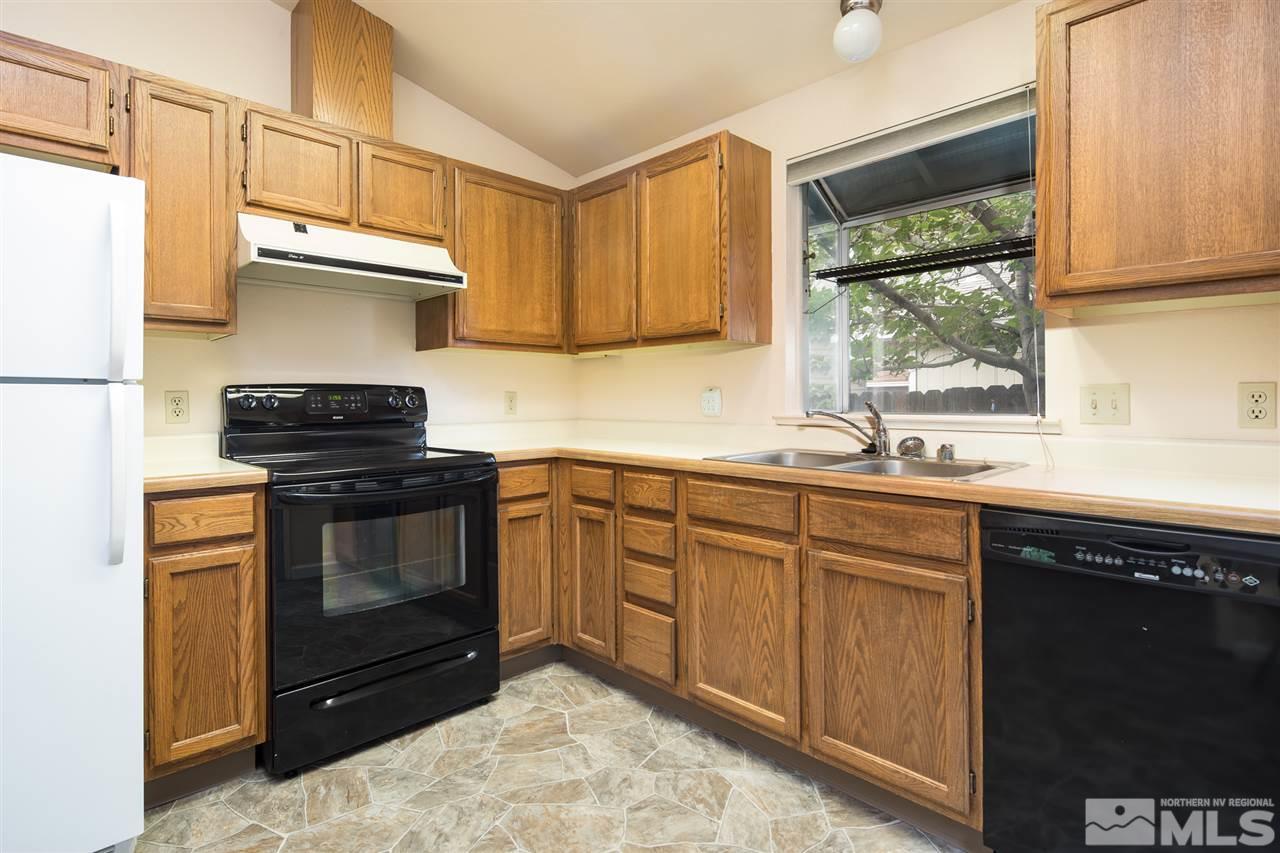 1262 Blue Lakes Road Reno, NV 89523 - Photo 8 of 19 a kitchen with stainless steel appliances granite countertop a stove a sink and a microwave