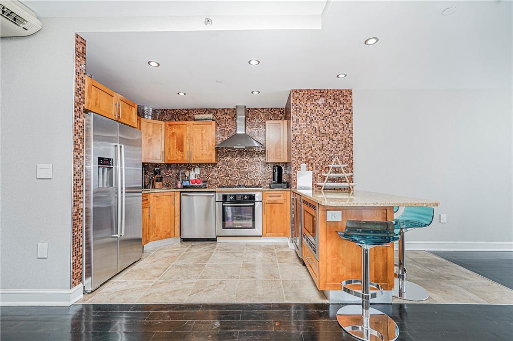 1702 Avenue Z, Unit 6B Brooklyn, NY 11235 - Photo 11 of 40 a kitchen with granite countertop a sink a counter top space and stainless steel appliances