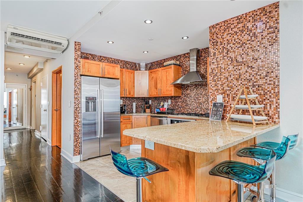 1702 Avenue Z, Unit 6B Brooklyn, NY 11235 - Photo 12 of 40 a large kitchen with a table and chairs