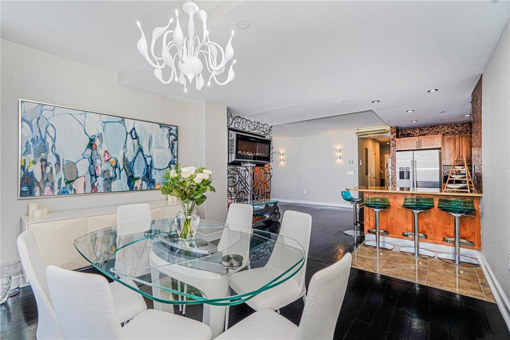1702 Avenue Z, Unit 6B Brooklyn, NY 11235 - Photo 16 of 40 a view of a dining room with furniture a livingroom and chandelier