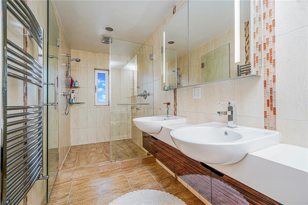 1702 Avenue Z, Unit 6B Brooklyn, NY 11235 - Photo 22 of 40 a bathroom with a bathtub and a sink