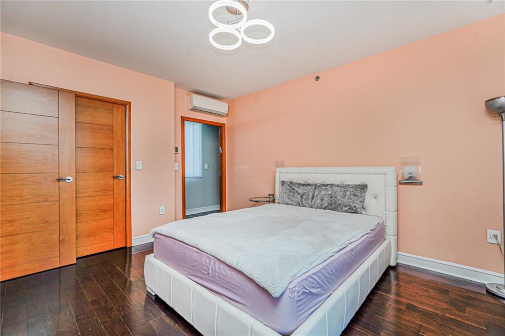 1702 Avenue Z, Unit 6B Brooklyn, NY 11235 - Photo 25 of 40 a bedroom with a bed and wooden floor