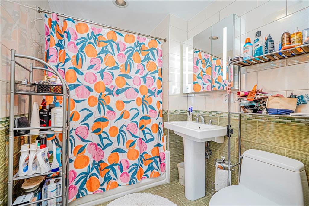 1702 Avenue Z, Unit 6B Brooklyn, NY 11235 - Photo 33 of 40 a bathroom with a sink and a toilet