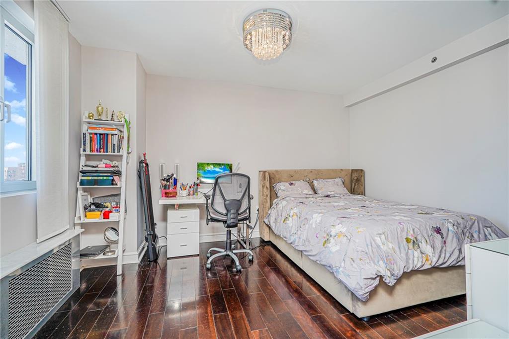 1702 Avenue Z, Unit 6B Brooklyn, NY 11235 - Photo 34 of 40 a bedroom with a bed and a table in it