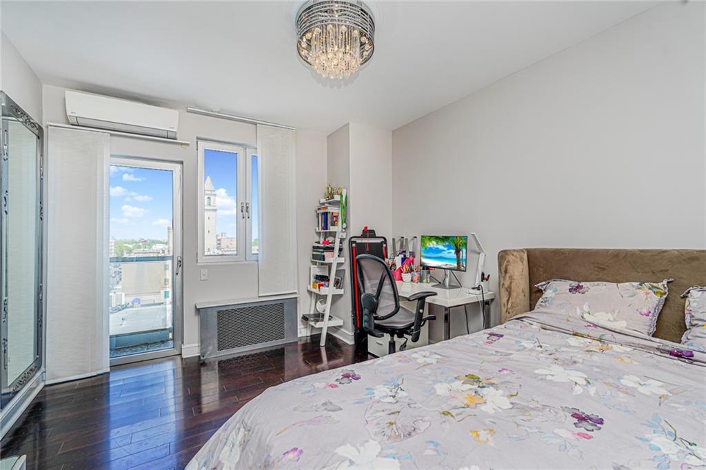 1702 Avenue Z, Unit 6B Brooklyn, NY 11235 - Photo 35 of 40 a bed room with a bed a table and a chandelier