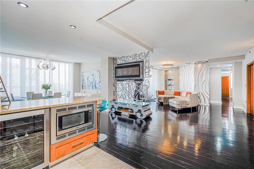 1702 Avenue Z, Unit 6B Brooklyn, NY 11235 - Photo 9 of 40 a living room with fireplace furniture and a wooden floor
