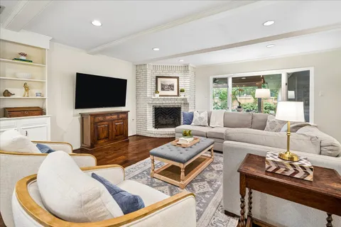 a living room with fireplace furniture and a flat screen tv