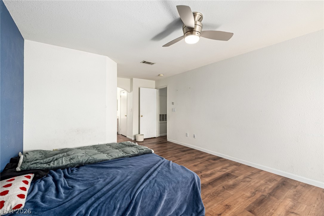 698 South Racetrack Road, Unit 124 Henderson, NV 89015 - Photo 15 of 29 Bedroom with a ceiling fan and dark wood finished floors