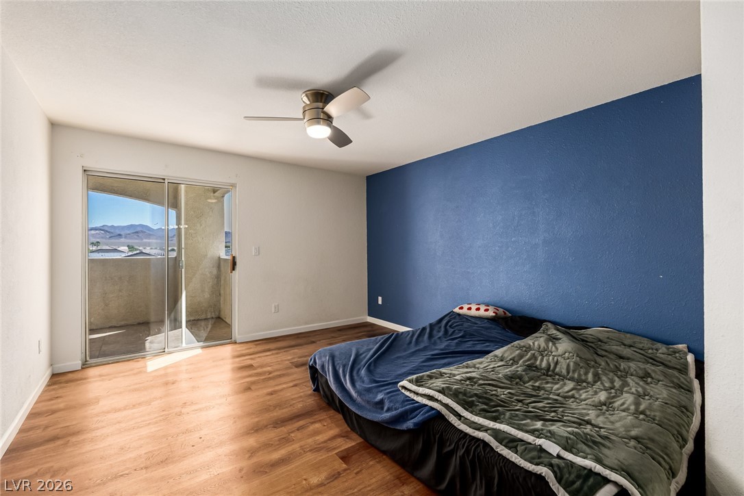 698 South Racetrack Road, Unit 124 Henderson, NV 89015 - Photo 16 of 29 Bedroom with wood finished floors, access to outside, and a ceiling fan