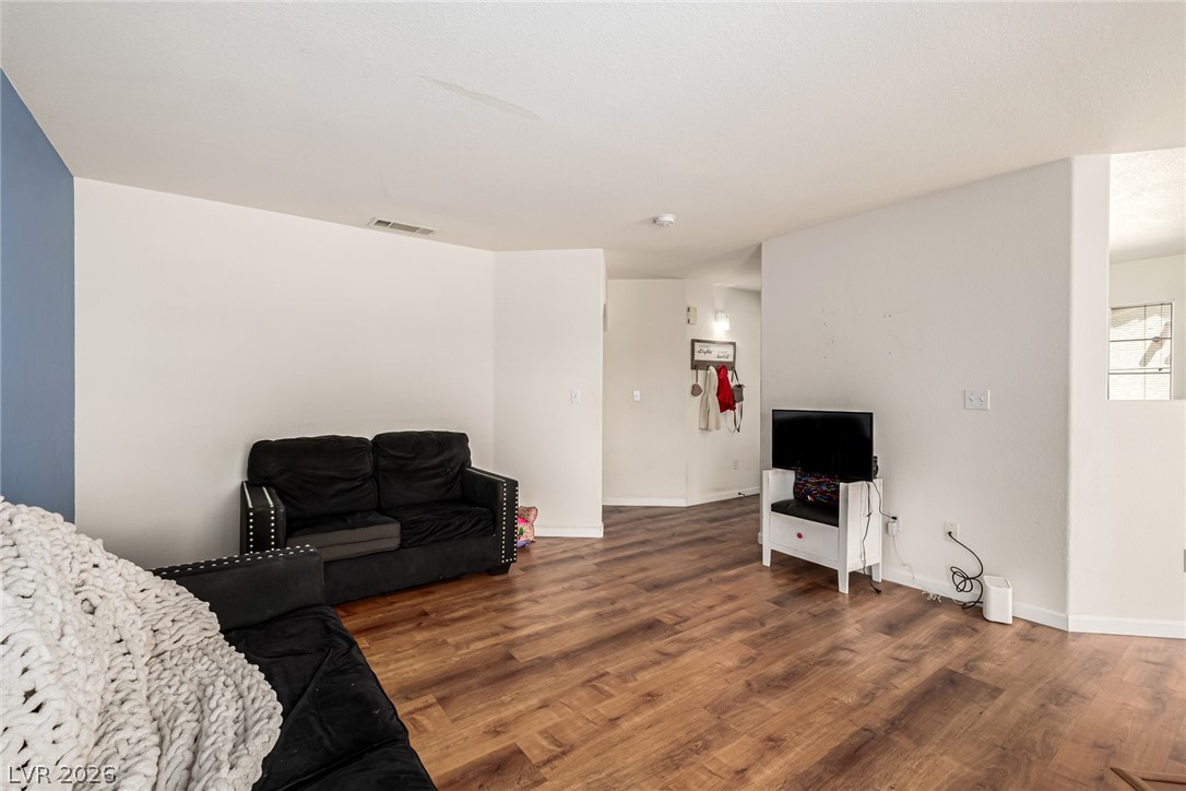 698 South Racetrack Road, Unit 124 Henderson, NV 89015 - Photo 6 of 29 Living room with wood finished floors and baseboards