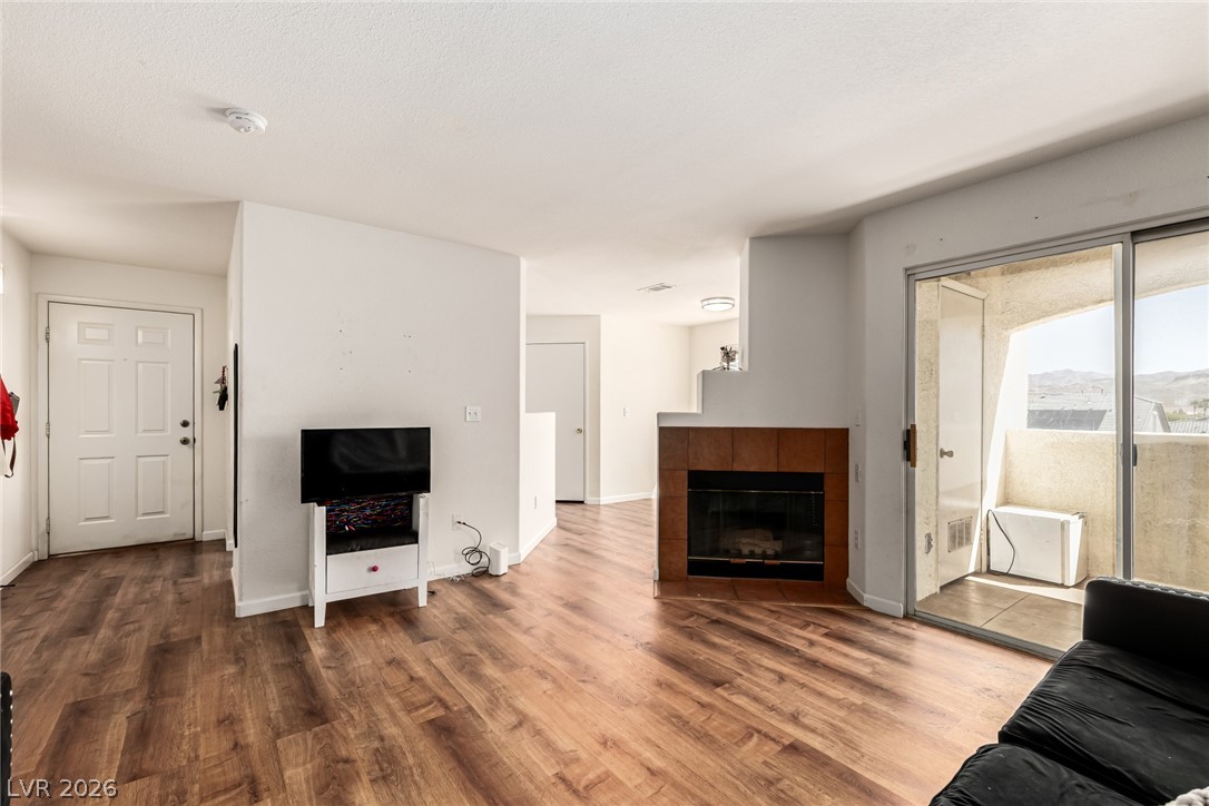 698 South Racetrack Road, Unit 124 Henderson, NV 89015 - Photo 7 of 29 Living room featuring wood finished floors and a fireplace