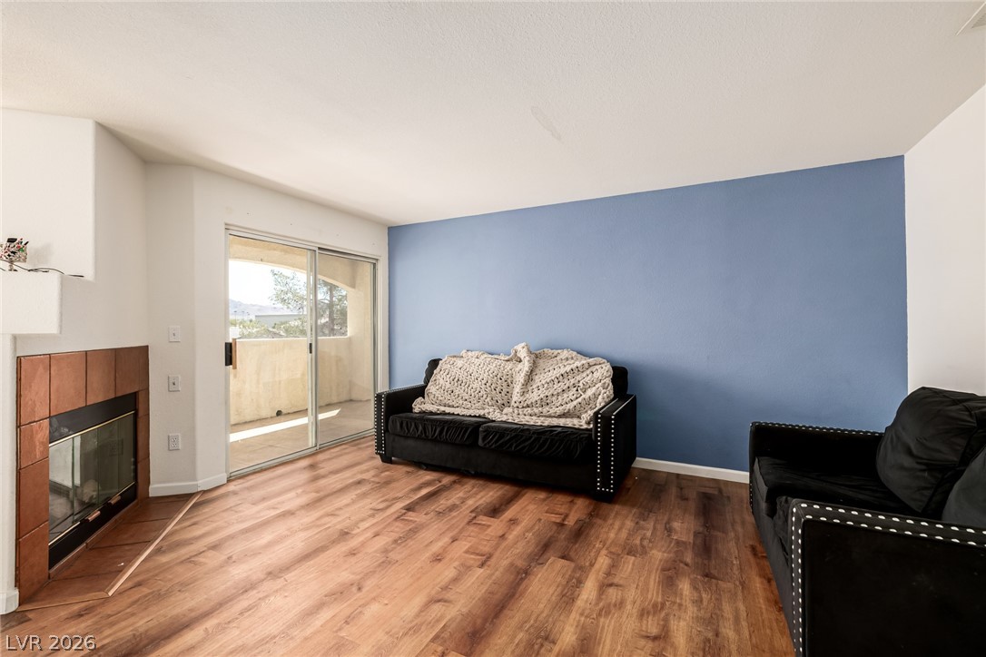 698 South Racetrack Road, Unit 124 Henderson, NV 89015 - Photo 8 of 29 Living area featuring wood finished floors and a fireplace
