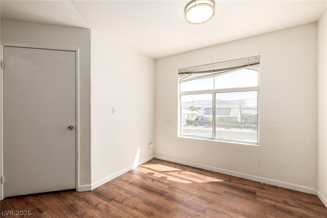 698 South Racetrack Road, Unit 124 Henderson, NV 89015 - Photo 9 of 29 Empty room featuring dark wood-type flooring and baseboards