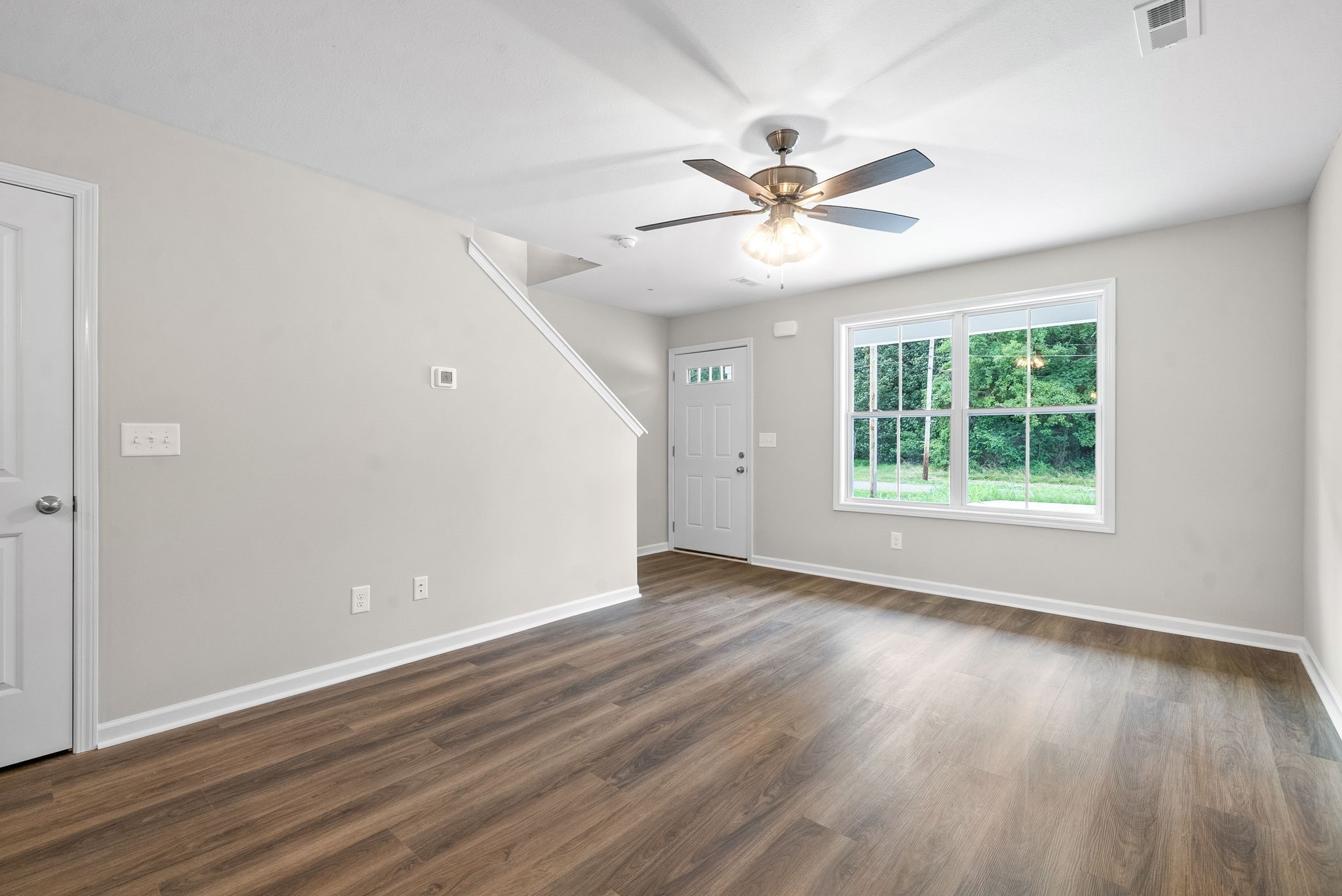 512 Edlin Street Clarksville, TN 37043 - Photo 4 of 20 a view of an empty room with wooden floor and a window