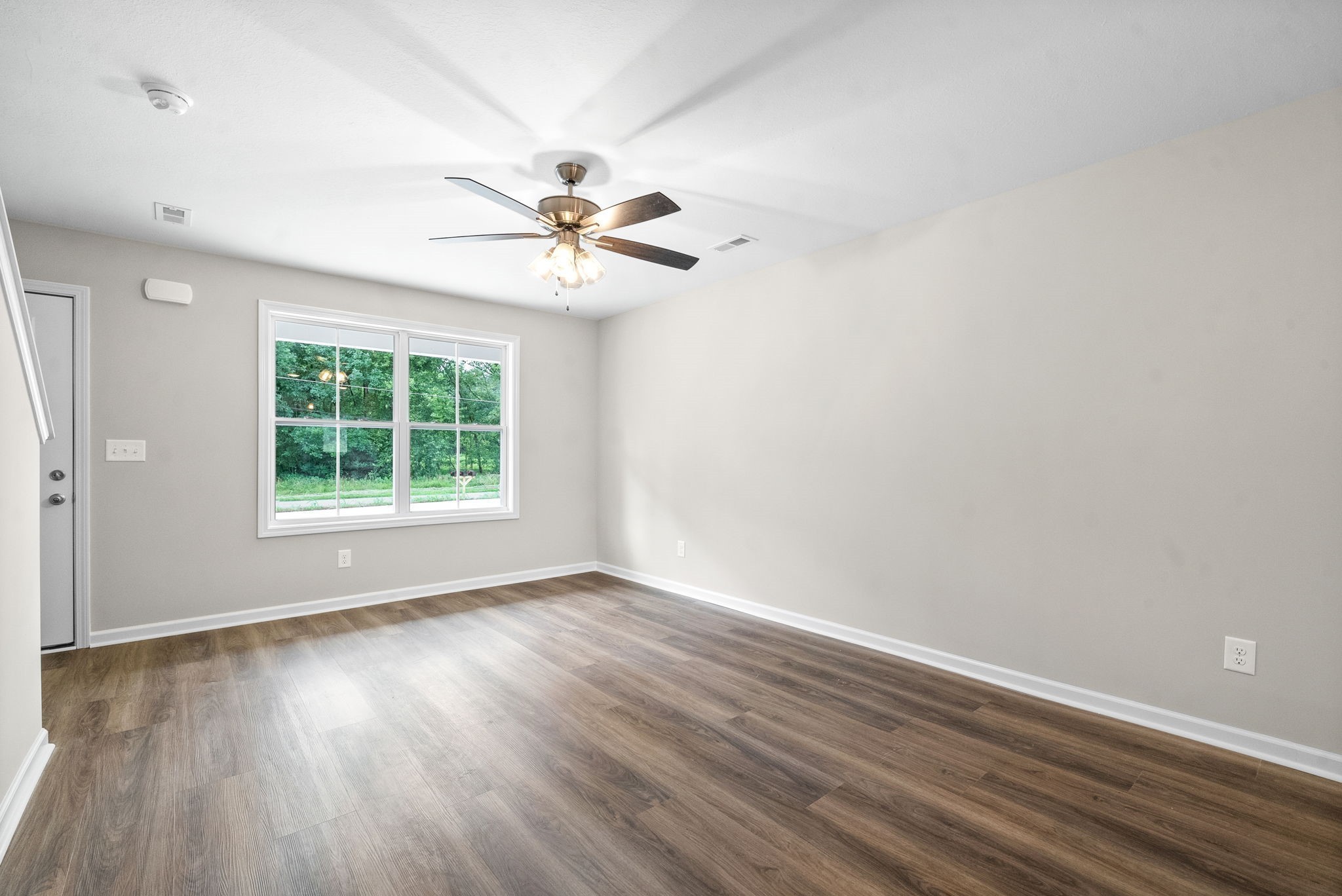 512 Edlin Street Clarksville, TN 37043 - Photo 5 of 20 a view of an empty room with wooden floor and a window