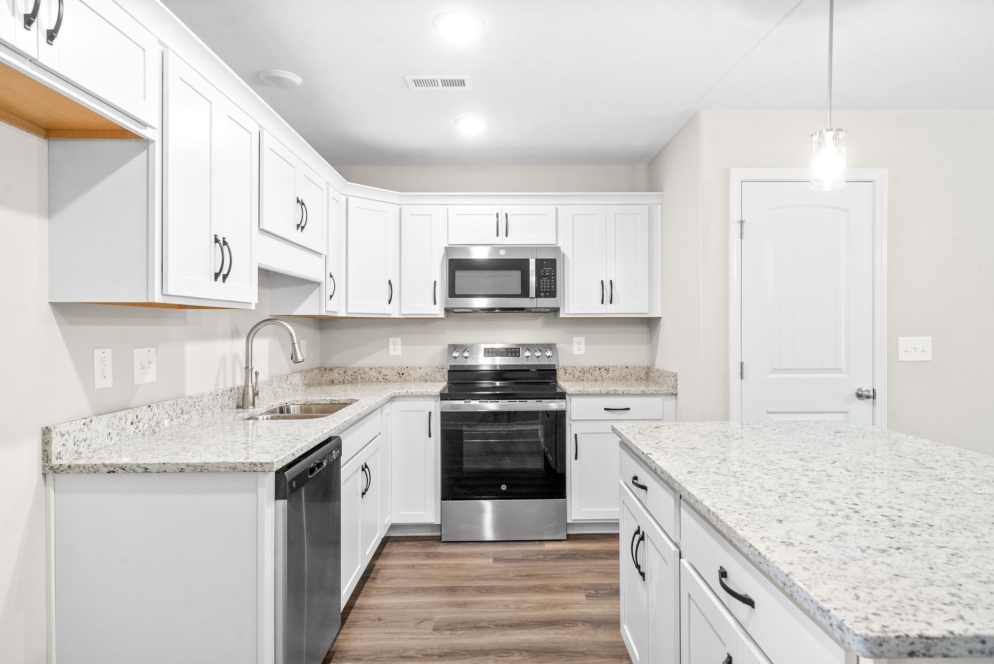 512 Edlin Street Clarksville, TN 37043 - Photo 8 of 20 a kitchen with granite countertop a sink and a stove top oven with white cabinets