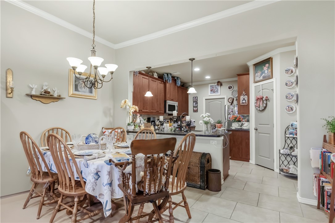 3815 Harvey Road College Station, TX 77845 - Photo 8 of 24 a kitchen with a dining table chairs and refrigerator