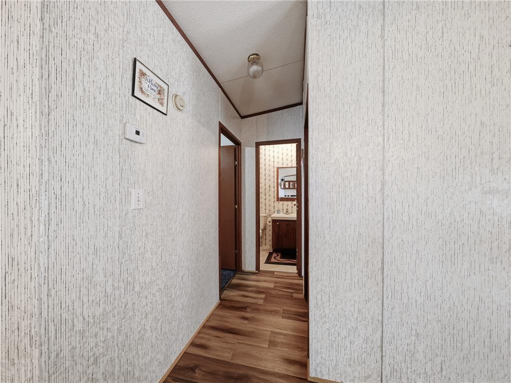 21210 137th Drive O'Brien, FL 32071 - Photo 15 of 49 a view of a hallway with wooden floor and staircase