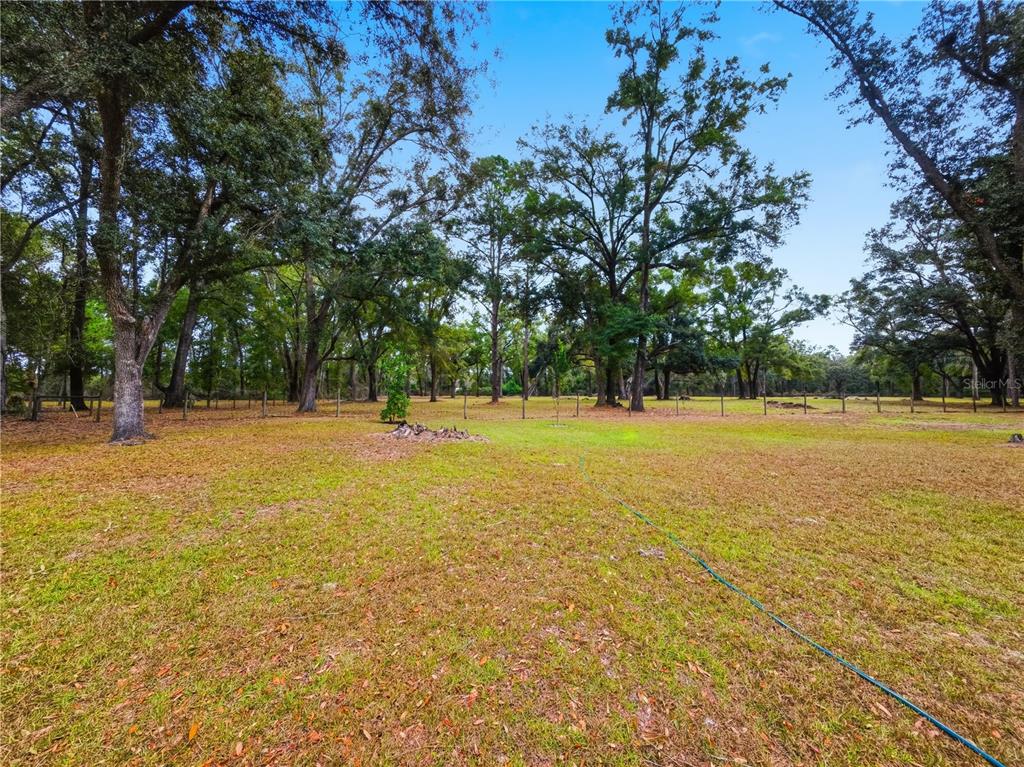 21210 137th Drive O'Brien, FL 32071 - Photo 25 of 49 a view of outdoor space with swimming pool and trees