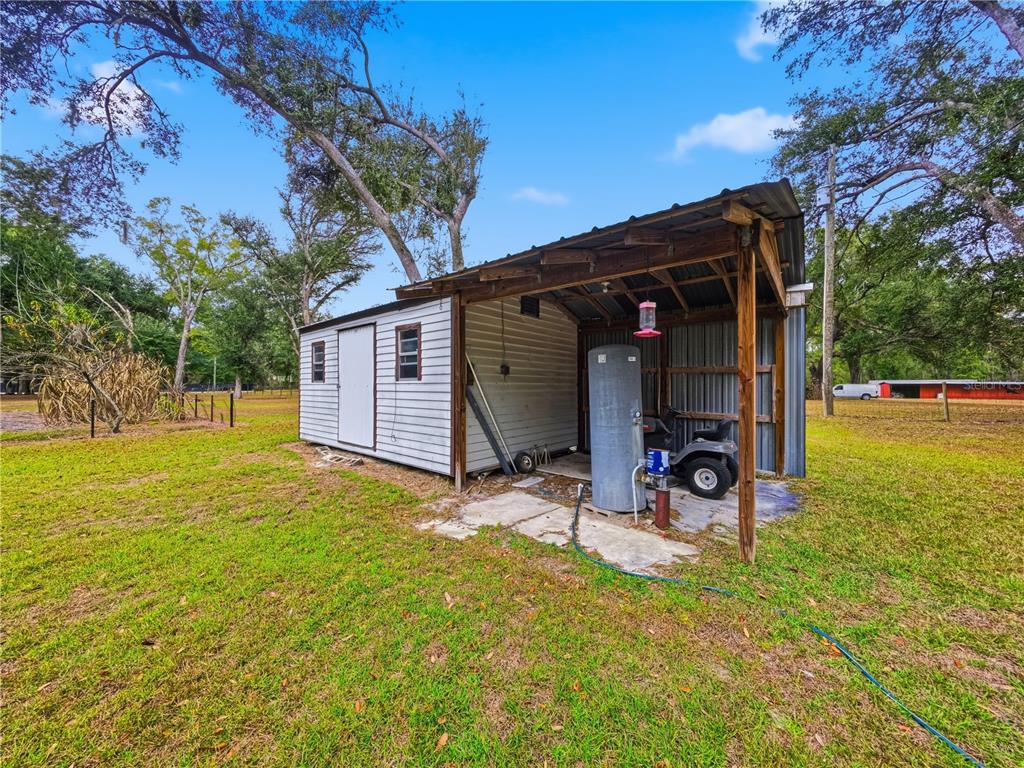 21210 137th Drive O'Brien, FL 32071 - Photo 35 of 49 a view of a backyard with table and chairs and floor to ceiling window