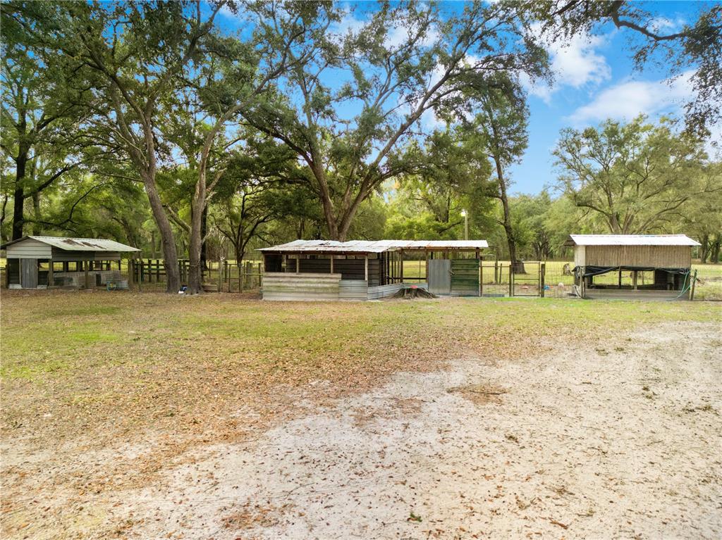 21210 137th Drive O'Brien, FL 32071 - Photo 40 of 49 a front view of a house with a garden