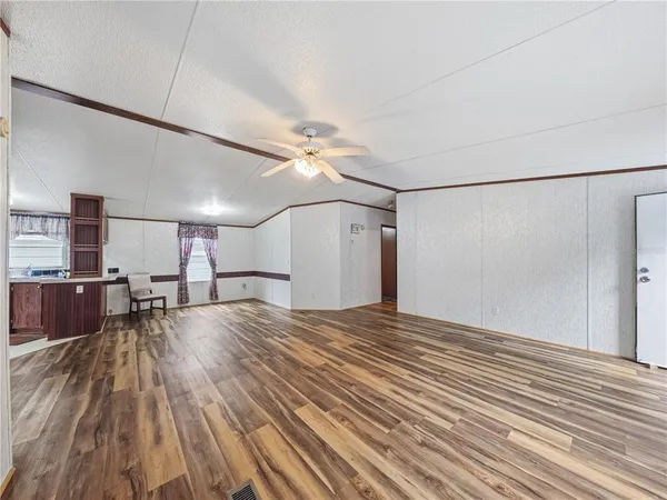 a view of a room with wooden floor