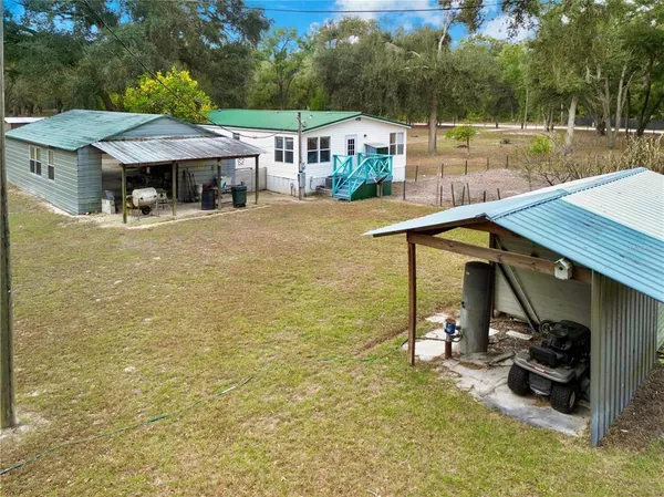 an aerial view of a house with a yard and pool