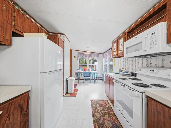 a kitchen with stainless steel appliances granite countertop a stove a refrigerator and a microwave