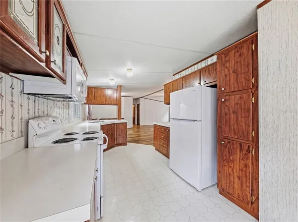 a view of kitchen with furniture and a refrigerator