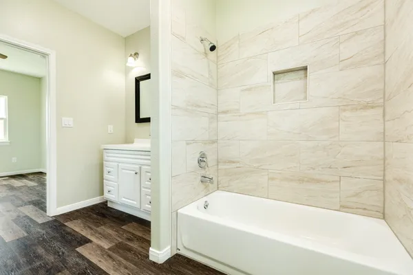 a bathroom with a bathtub and a shower