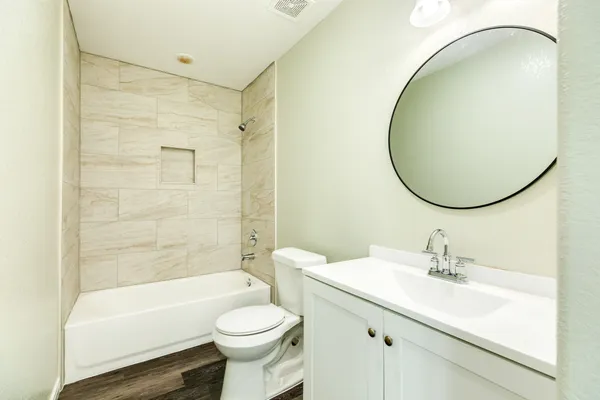 a bathroom with a sink a toilet and a mirror